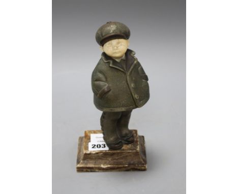 An Art Deco silver overlaid bronze and ivory figure of a boy wearing winter coat and cap, overall height 22cm, height of figu