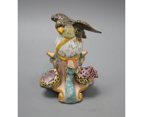 An early 19th century Staffordshire inkwell, modelled with an eagle perched upon a globe above three dolphins and shells, hei