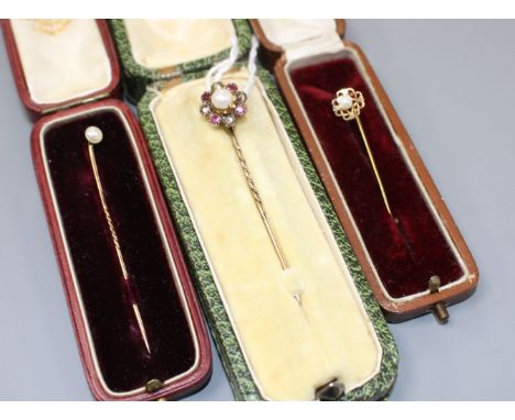 Three assorted yellow metal and gem set stick pins, including early 20th century, cultured pearl, ruby and rose cut diamond c