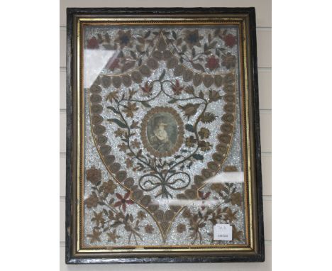 An early 19th century paper scroll work panel, formed with a printed miniature within a floral decorated shield, 50 x 35cm, o