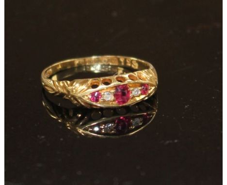 A George V 18ct gold, three stone ruby and two stone diamond set half hoop ring, size P, gross weight 1.9 grams. Condition: S