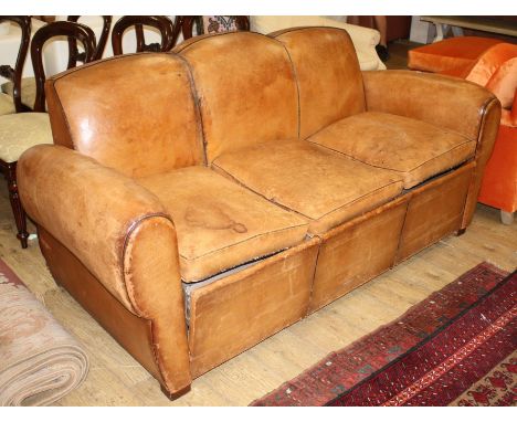 A French 1940's moustache back leather three seater sofa / sofa bed, W.188cm D.88cm H.89cm Condition: The tan leather is worn