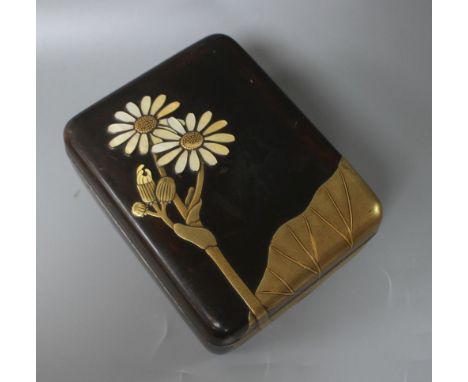 A Japanese Meiji period lacquer box, decorated with lotus leaves and flowers, with the petals inset with mother of pearl, sil