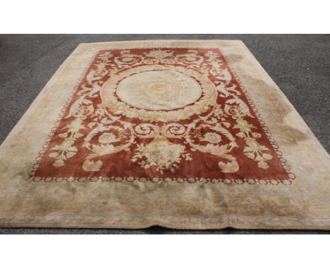 A Chinese terracotta ground carpet, 370 x 276cm Condition: Faded and dirty but no tears noted