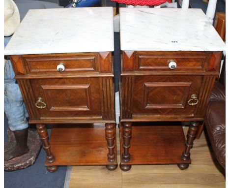 A pair of early 20th century French walnut bedside cupboards, with white marble tops, W.40cm D.39cm H.82cm Condition: Light s
