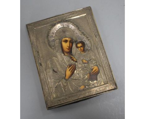 A Russian white metal overlaid tempera on panel icon, depicting the Virgin Mary and Christ child, 22 x 17.5cm Condition: Look