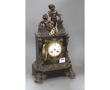 A Victorian bronze mounted black slate mantel clock, with enamelled dial, surmounted with figures of putti, height 48cm Condi