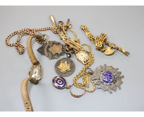 A yellow metal albert stamped 9c, hung with three medallions including 9ct gold masonic, a 9ct gatelink bracelet(a.f.), an un