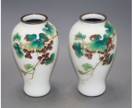 A pair of Japanese cloisonne silver wire vases, decorated with grapes on a white ground, height 18.5cm Condition: Both vases 