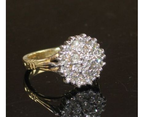 A modern 18ct gold and diamond cluster ring, size M, gross weight 7.8 grams. Condition: Some minor surface scratches to the s