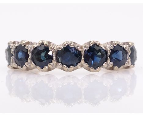 White gold seven stone sapphire ring stamped 18ct   Condition Report  Approx 4.6gm size N Click here for further images, cond