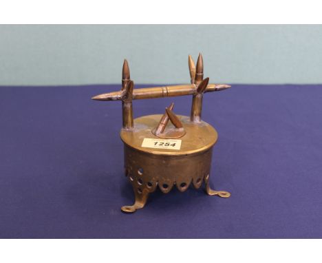A 'Trench Art' inkwell and pen stand crafted from an 18 pr shell case dated 1916 and several cartridges