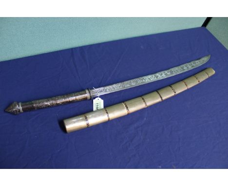 A mid 19th Century Burmese sword (DHA) with heavily engraved blade (24") and decorated white metal covered grip, with its ori