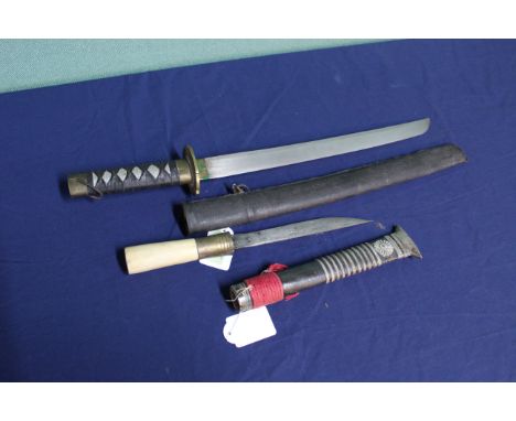 A Wakizashi style knife in scabbard with a small DHA in white metal embellished sheath