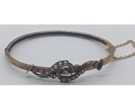 A 15ct yellow gold bangle, mounted with pearls and a single diamond, 6g