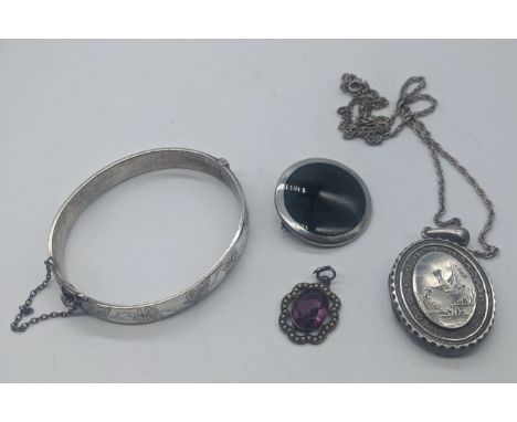 A collection of silver jewellery to include a bangle, a locket, a pendant with purple stone and a Scottish agate brooch, vari