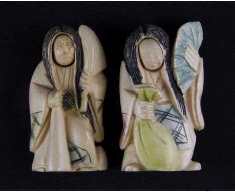 Two 19th Century Japanese carved and inked ivory netsuke with changing faces, H. 5cm.