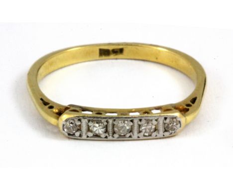 An 18ct yellow gold (stamped 18ct) 5 diamond set ring, (O.5).