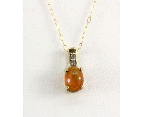 A 9ct yellow gold pendant and chain set with a cabochon cut opal and a diamond, L. 1.4cm.