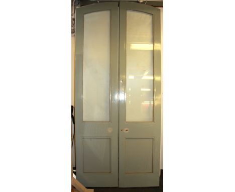 Architectural salvage interest. A pair of large arched heavy quality pine and glass doors, H. 250cm W. 110cm.
