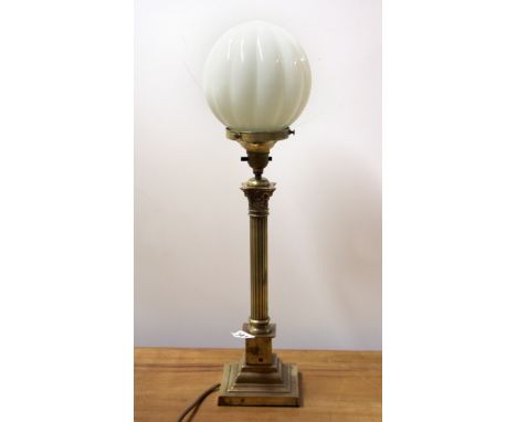 An antique brass column table lamp with glass shade, H. 52cm.