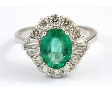 An 18ct white gold (stamped 750) ring set with an oval cut emerald and baguette and brilliant cut shoulders, approx. 1.87ct e