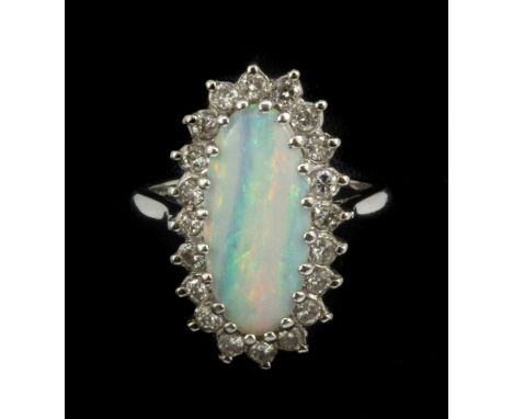 An 18ct white gold (worn stamp 18ct) cluster ring set with a cabochon cut opal and brilliant cut diamonds, approx. 0.6ct diam