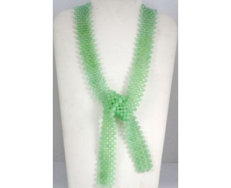 A polished jade bead tying necklace, L. 95cm.