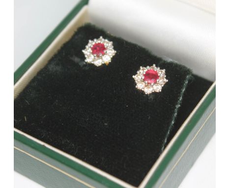A pair of hallmarked 18ct white gold diamond and ruby cluster ear studs, diam. approx. 7mm, gross wt. 2.5g.  