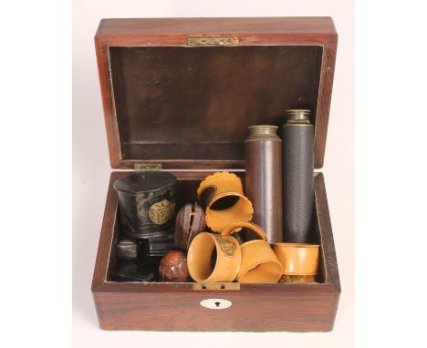 A 19th century box and contents comprising two telescopes, six Mauchline ware serviette rings, two cheroot holders and variou