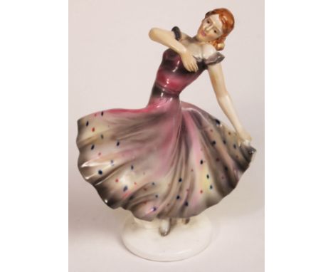 An Art Deco pottery figure depicting a dancer, height 29cm.  Condition: restoration to hand, crazing etc.
