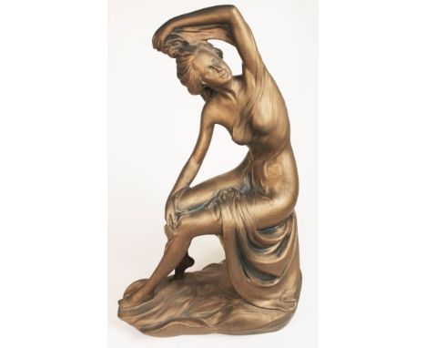 A modern Art Deco style plaster figure depicting a semi nude lady, signed 'Italy' to base, height 62cm.  Condition: no signs 