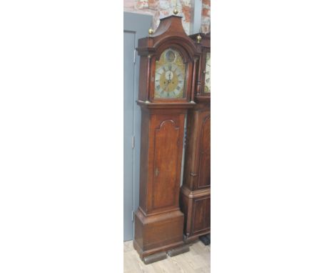 A Georgian oak eight day longcase clock, the hood with arched top, three brass finials and brass terminated oak columns, the 