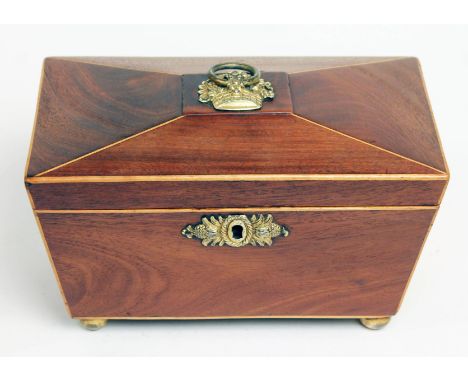 A Georgian walnut tea caddy of sarcophagus form, boxwood strung, gilt brass mount and ball feet, length 21cm.  