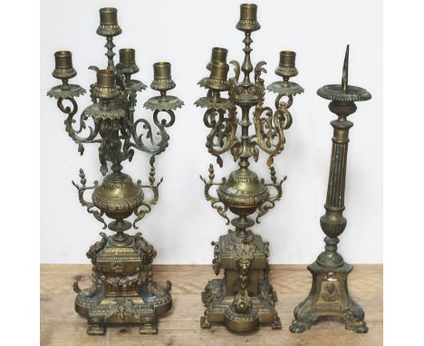 A pair of brass candelabra and a church pricket candle stick, height approx. 55cm.  