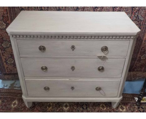 GUSTAVIAN STYLE COMMODE, traditionally grey painted with three long drawers, canted corners and tapering supports, 100cm W x 