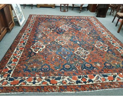 An antique Bakhtiari carpet, West Iran, 323 cm x 393 cm CONDITION REPORT: The carpet is in good condition. The pile is worn a