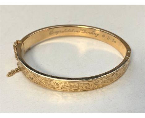 A 9ct gold bangle  CONDITION REPORT: 12.3g. Internal measurements 6cm by 5cm. The bangle appears to be in good condition. Ins