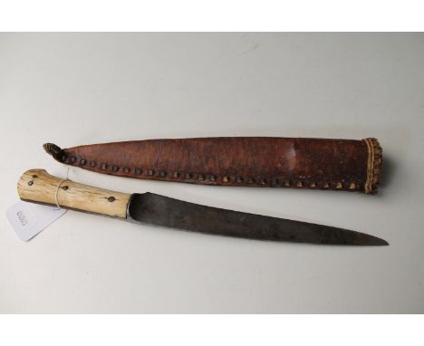 An Eastern dagger with bone hilt in leather scabbard  CONDITION REPORT: Length 30cm overall. Blade pitted. Section of grip re