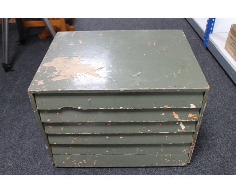A wooden multi drawer chest and a metal chest containing tools 