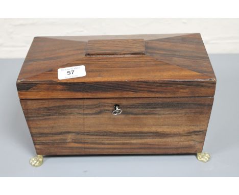 A Regency rosewood tea caddy on brass paw feet