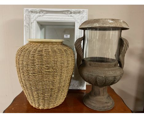 A metal candle pot, a white mirror and a wicker and ceramic vase 