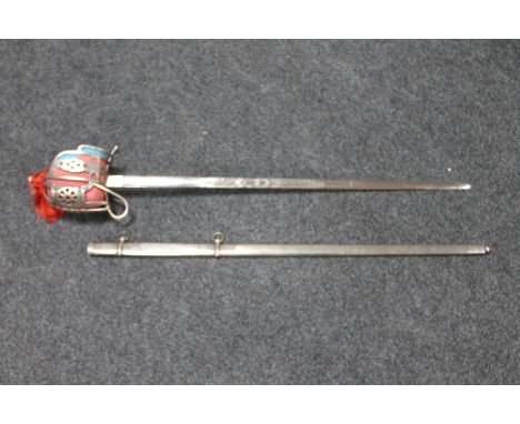 A basket hilted sword in scabbard  CONDITION REPORT: Blade 80cm. In good condition. See images. 