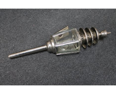 An antique chrome coach lamp