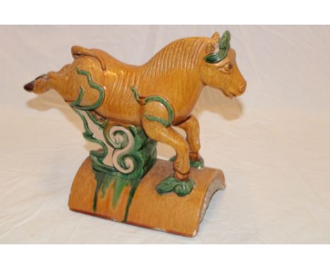 A Japanese glazed terracotta ridge tile finial in the form of a leaping horse 7" high x 13" long