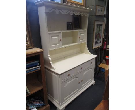 A painted pine dresser, the shelf back above three drawers and two cupboards to the base, 132cm wide, 193cm high  