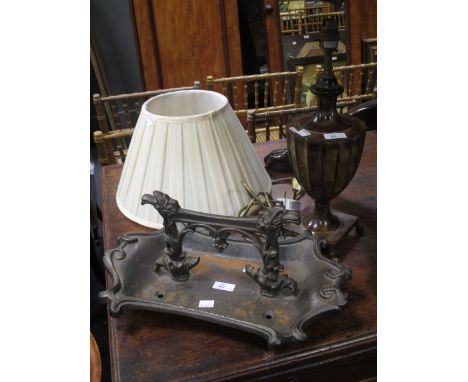 A Victorian cast iron boot scraper and a neoclassical design table lamp  