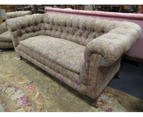 A paisley upholstered Chesterfield button back sofa and matching armchair (2)  