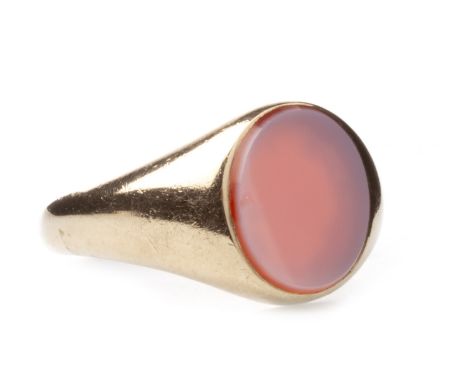 GENTLEMAN'S SIGNET RING, set with an oval section of red to white hardstone 13mm long, in nine carat gold, size R, 7.7g