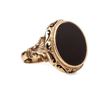 BLACK HARDSTONE RING, the oval section of hardstone within an openwork border, on moulded shoulders, unmarked, size T 1/2, 7.